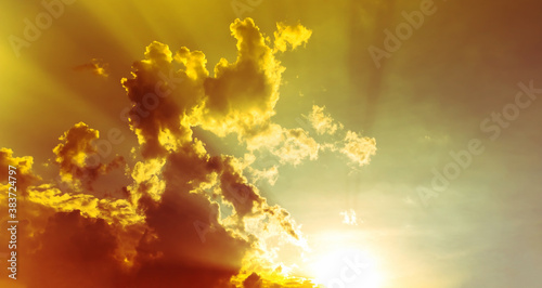 sky and clouds nature background, bright yellow sunset light in overcast sky with soft clouds