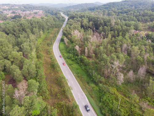 aerial view of winding road in a forest