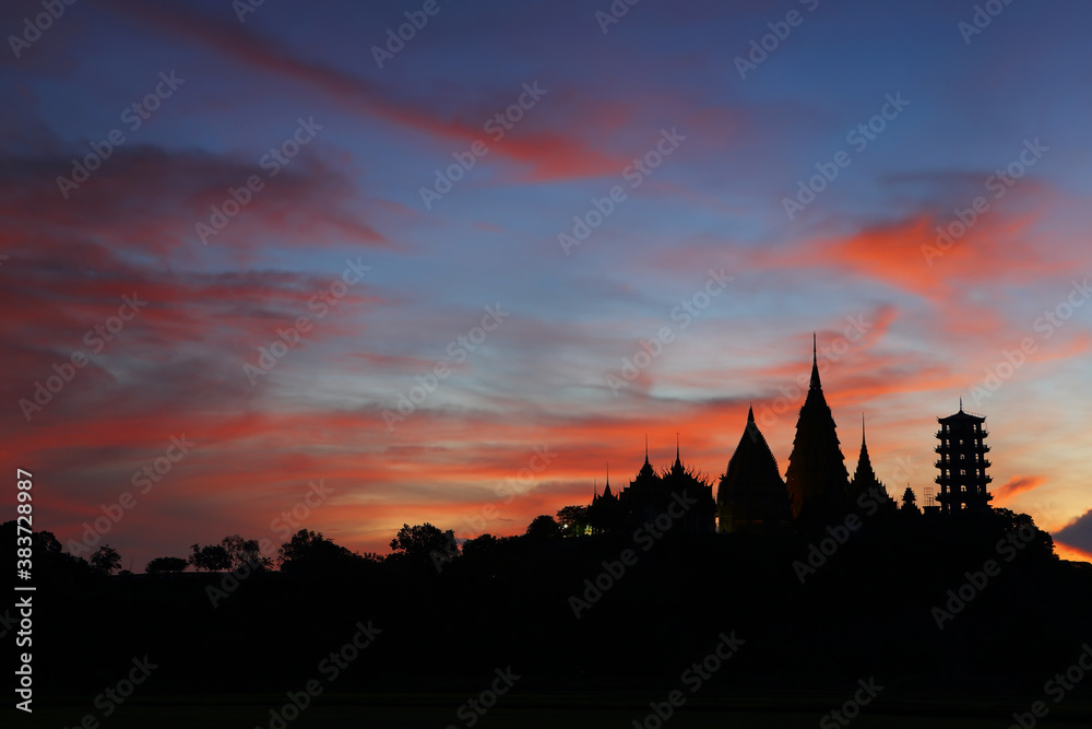 Silhouette of Wat Tham Sua (Tiger Cave Temple) is one of famous temples in the beautiful sunrise in Kanchanaburi province in Thailand