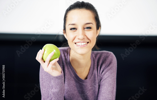 portrait of a beautiful young woman wiyh green apple photo