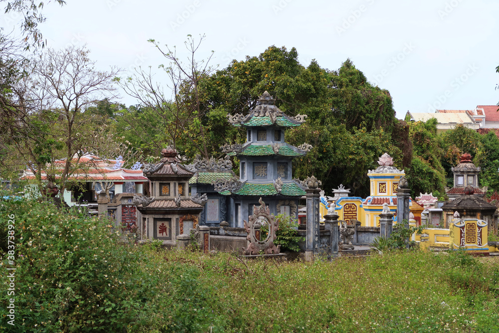 Hoi An, Vietnam, March 3, 2020: Colorful tombs in the gardens of the Chùa Chúc Thánh temple. Hoi An, Vietnam