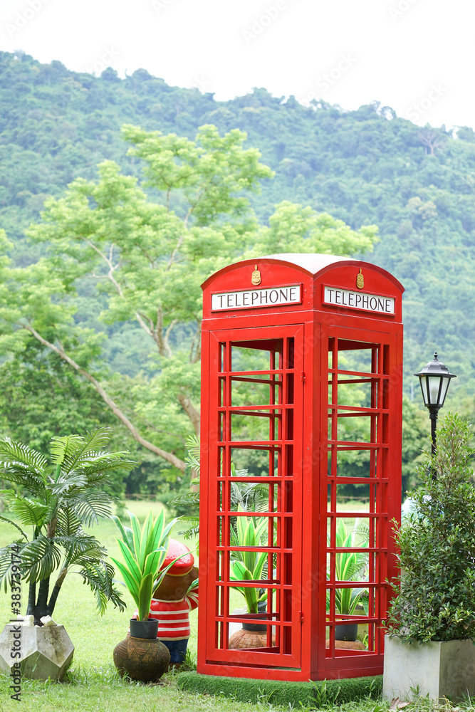 Obraz premium Telephone booth old red in the garden.