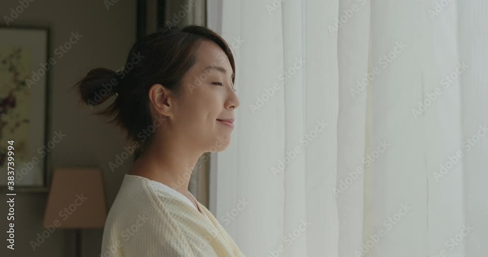 Woman look outside window at room in morning time