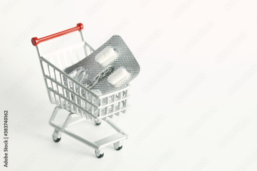 Miniature shopping cart model and medicine scene represent medical and treatment business concept related idea. Miniature shopping cart model and medicine scene represent medical and treatment business concept related idea.