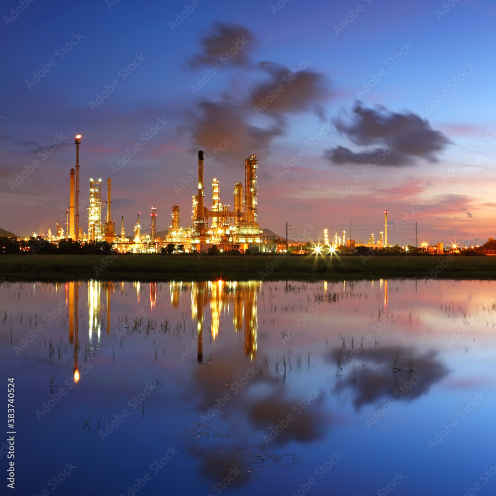 Fototapeta premium Industrial view of oil refinery factory with water reflection at sunrise, In the east of Thailand