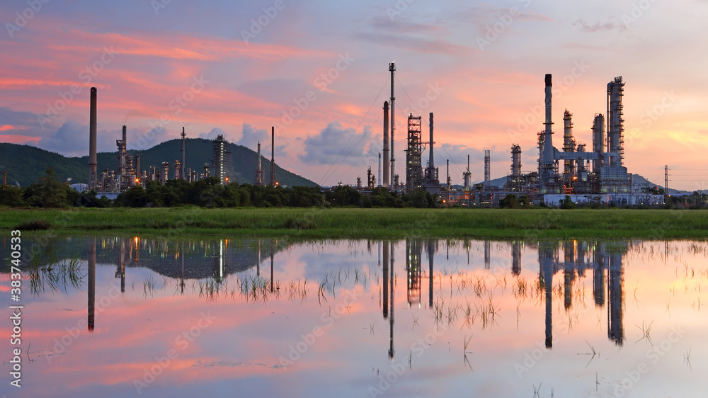 Industrial view of oil refinery factory with water reflection at sunrise, In the east of Thailand