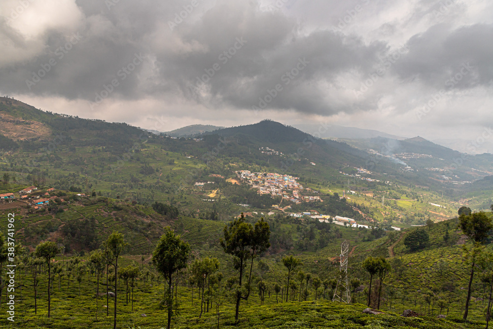 mountain and city landscape with clouds and the beautiful tea plantations in ooty.

