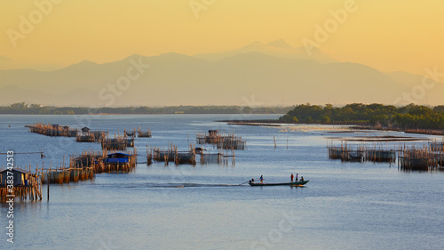 Aquaculture with fishing boats sailing at morning light in Chanthaburi Thailand