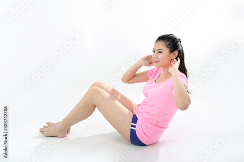 beautiful young south east Asian Chinese woman exercise workout sit ups on white background
