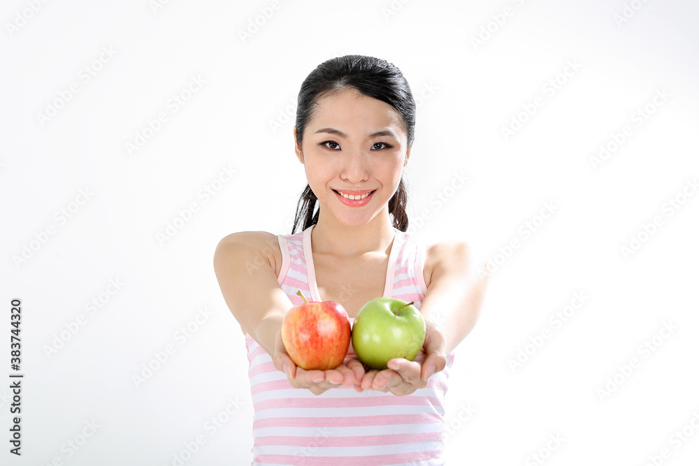 beautiful young south east Asian Chinese woman holding healthy green and red apple on white background beautiful young south east Asian Chinese woman holding healthy green and red apple on white background