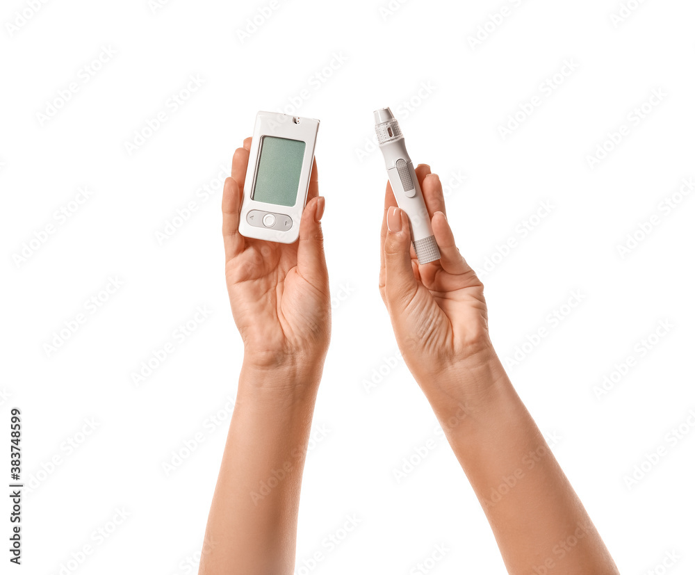 Female hands with glucometer and lancet pen on white background. Diabetes concept Female hands with glucometer and lancet pen on white background. Diabetes concept