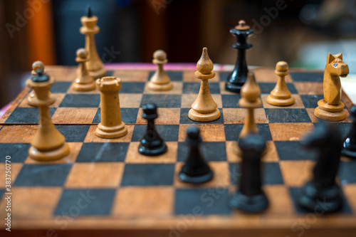 Chess game on the old vintage wooden board