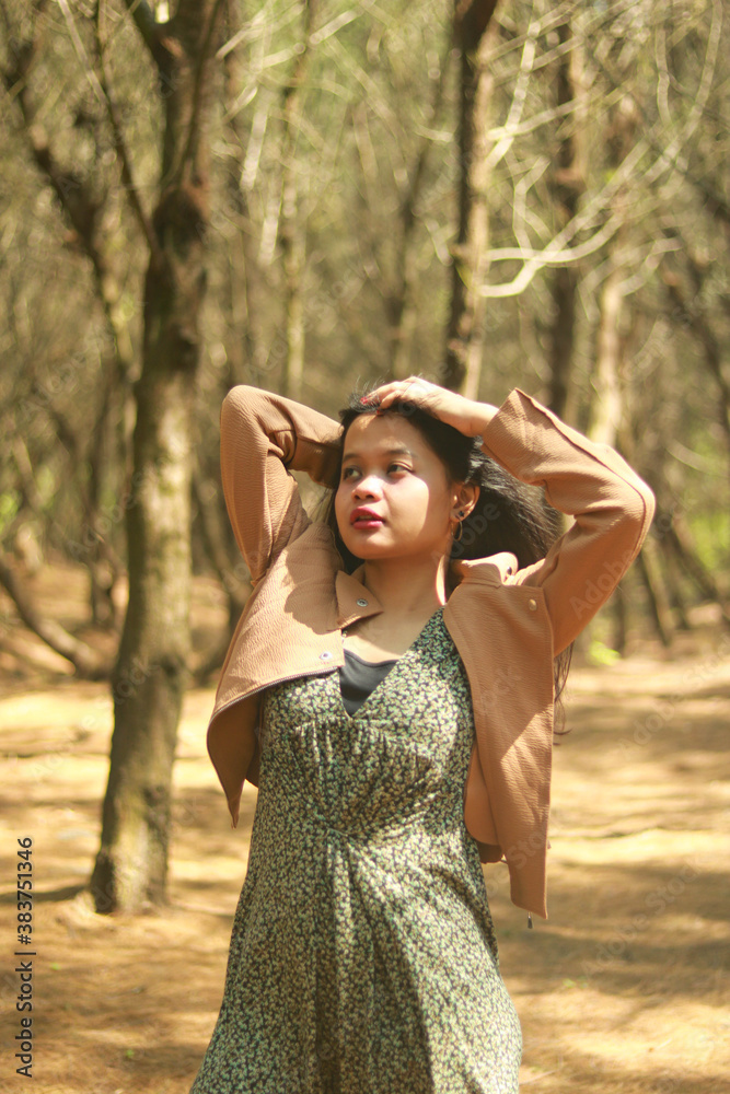 Naklejka premium Outdoor lifestyle portrait of beautiful young asian woman on the beach.