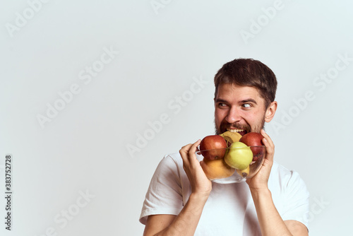 man with fresh fruit in a glass cup gesturing with hands vitamins health energy model bushy beard mustache