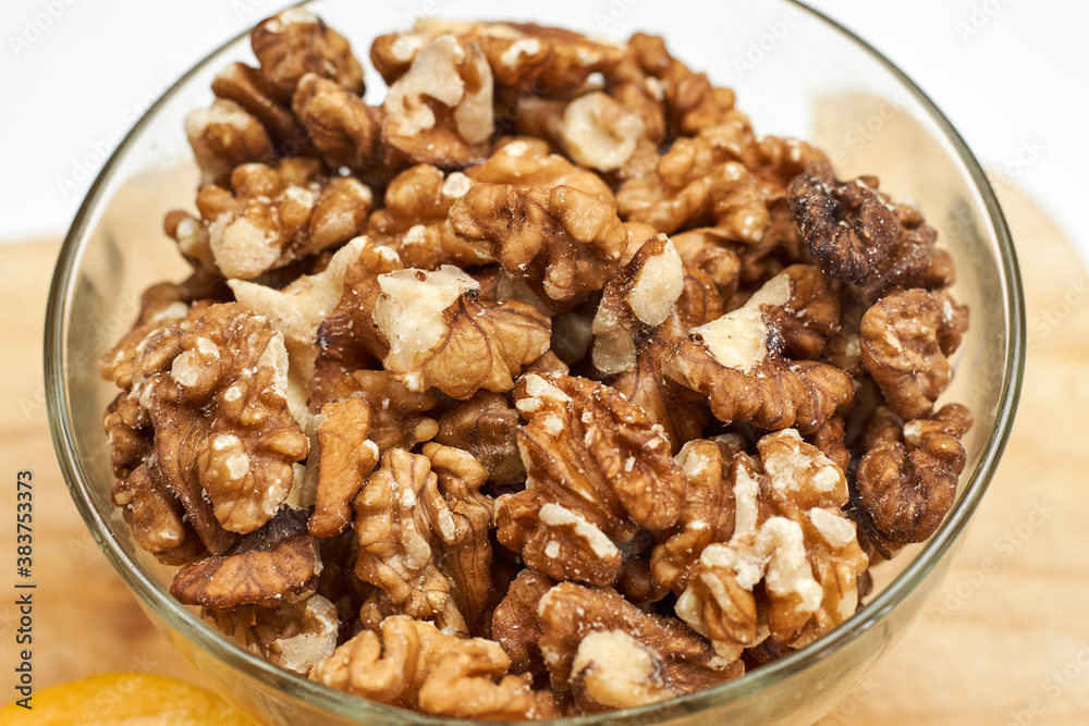 Peeled and cracked walnuts for snack. Close-up view of a bowl of walnuts. Peeled and cracked walnuts for snack. Close-up view of a bowl of walnuts.