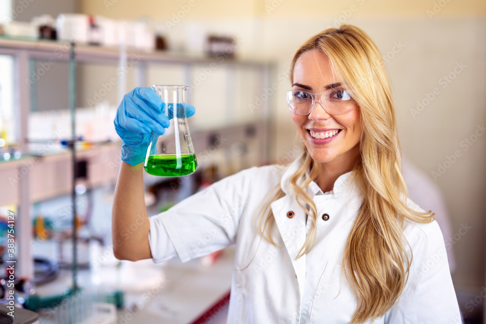 Attractive young woman scientist working in laboratory Attractive young woman scientist working in laboratory
