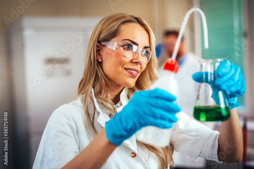 Attractive young woman scientist working in laboratory
