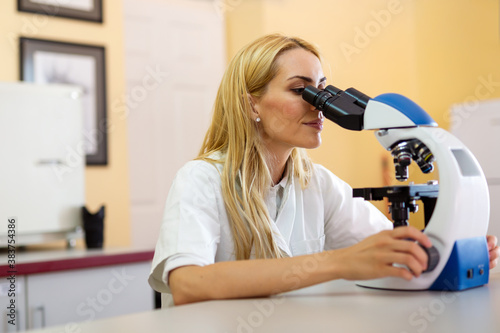 Scientist using a microscope in a laboratory  Testing for coronavirus covid19 vaccine