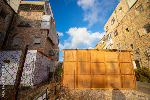 A beautiful sukkah made of wood inside the courtyard of a building, Jerusalem, Israel. photo