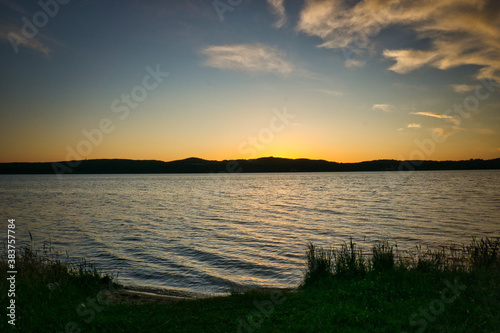 Sunset on a lake in June with clouds © Ronny