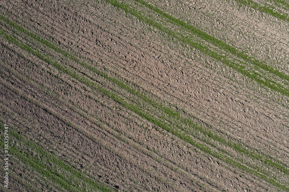Picture of an aerial view with a drone of a field and field with tractor tracks in the Bavarian forest near Grafenau, Germany Picture of an aerial view with a drone of a field and field with tractor tracks in the Bavarian forest near Grafenau, Germany