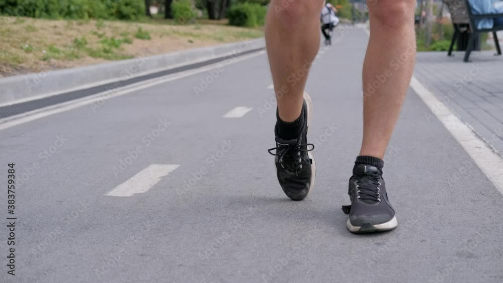 Handsome man jogging in the park. Sportsman runs exercising training outdoors. Handsome man jogging in the park. Sportsman runs exercising training outdoors.