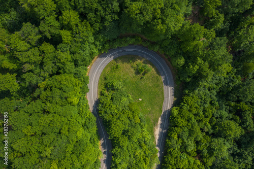 Visegrad, Hungary - Aerial top down view of curvy road in forest. 