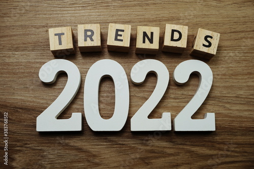 Trends 2022 word alphabet letters on wooden background