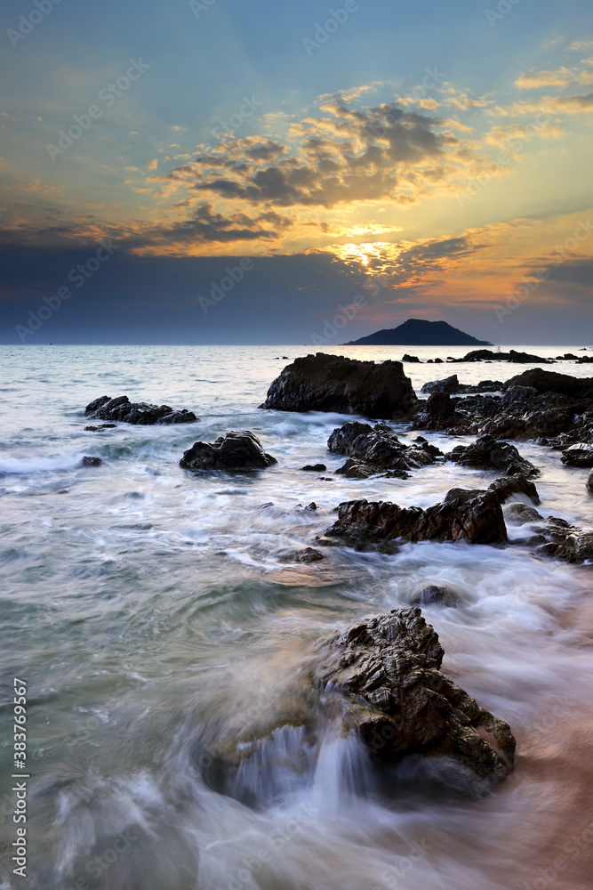 Dramatic seascape of Sea waves crashing against rocks in Krating Bay at beautiful sunset in Chanthaburi, Thailand, summer sea concept