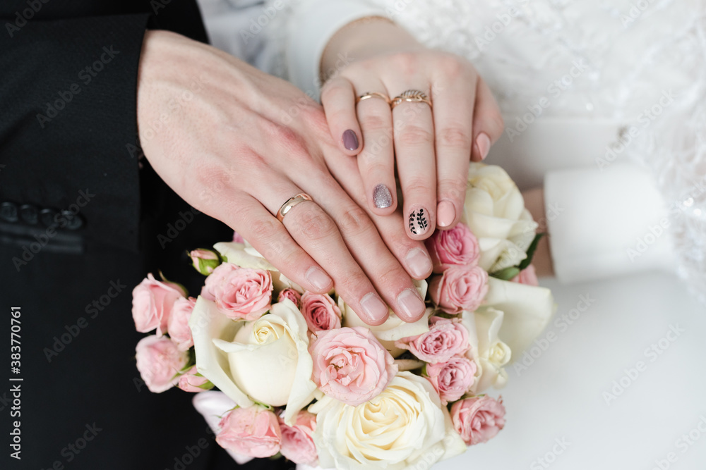 hands with wedding rings, wedding rings, bridal bouquet of pink roses hands with wedding rings, wedding rings, bridal bouquet of pink roses