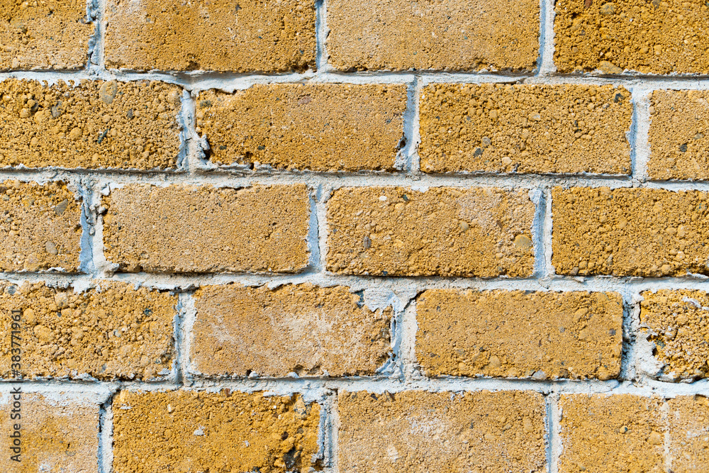 Fototapeta premium background from a miniature houses in a city park, yellow brick wall and windows