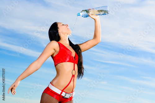 sport girl in red uniform with a bottle of water photo
