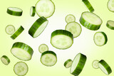 Falling cucumber slices isolated on a colored background with clipping path. Flying vegetables