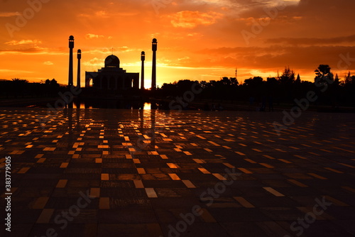 Sunset view with red clouds, golden yellow, colorful sky at the Central Mosque, Songkhla Province. photo