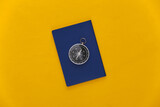 Compass and passport on a yellow background. Top view. Minimalism travel concept. Flat lay