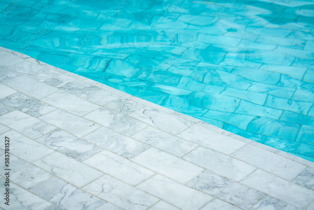 Luxury swimming pool which is built from white marble rock material