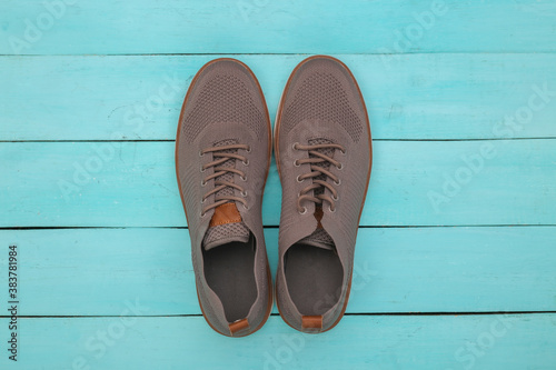 Men's shoes on blue wooden background. Top view