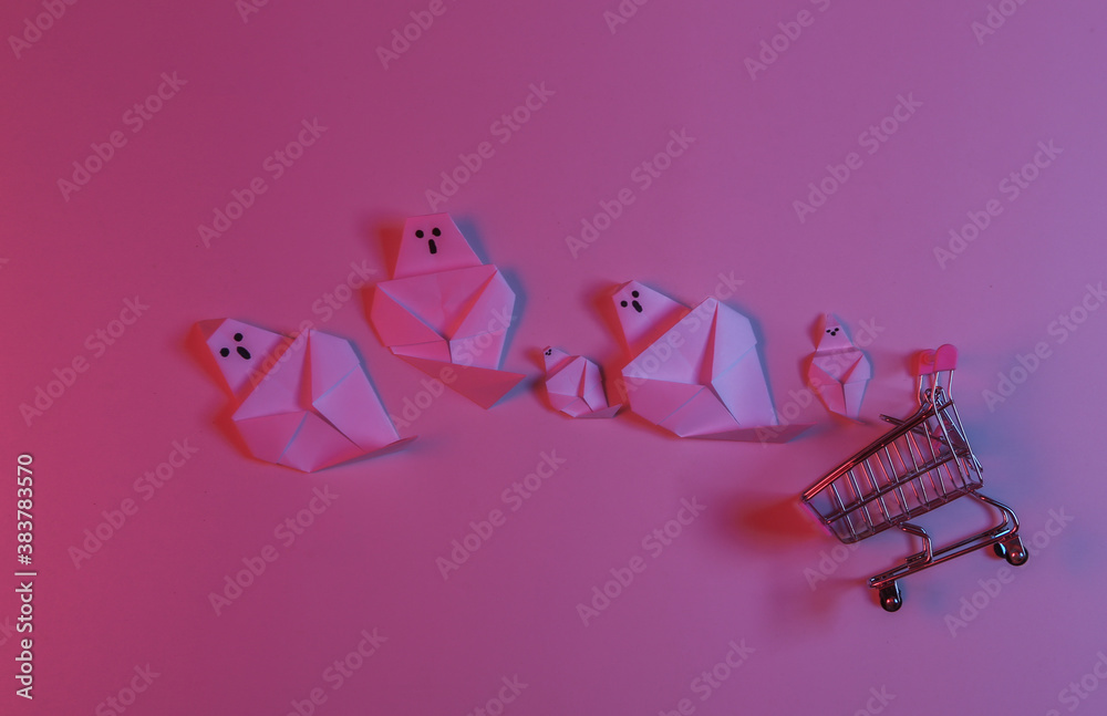 Paper Origami ghosts and shopping trolley in red blue neon light. Halloween theme Paper Origami ghosts and shopping trolley in red blue neon light. Halloween theme