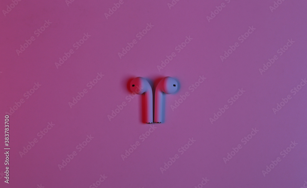 Wireless headphones in neon red blue neon gradient light. Wireless headphones in neon red blue neon gradient light.
