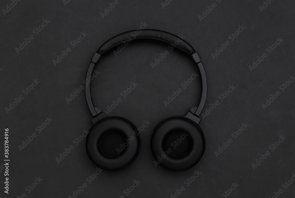 Wireless stereo headphones on a black background. Top view Wireless stereo headphones on a black background. Top view