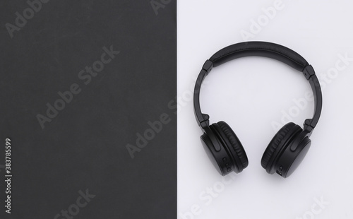 Wireless large stereo headphones black white background. Top view. Copy space