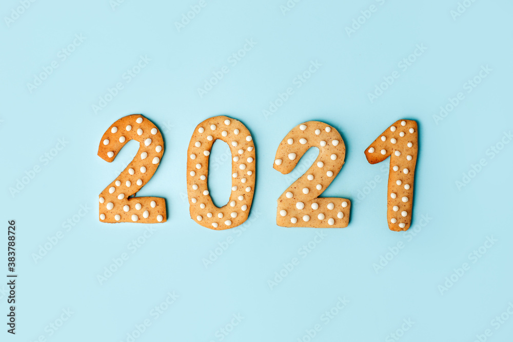 Happy New Year's set of numbers 2021 from ginger biscuits glazed sugar icing decoration on blue background, minimal seasonal winter holiday card, banner, flyer, coupon