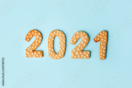 Happy New Year's set of numbers 2021 from ginger biscuits glazed sugar icing decoration on blue background, minimal seasonal winter holiday card, banner, flyer, coupon