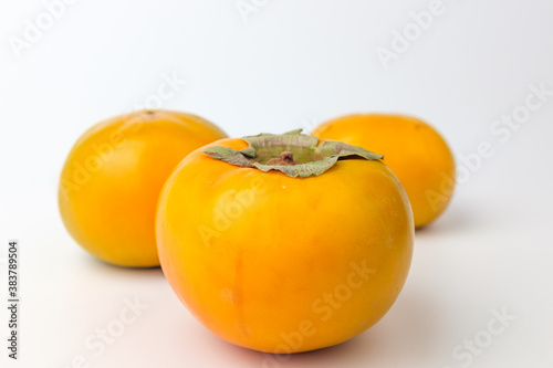 Orange persimmon on white background