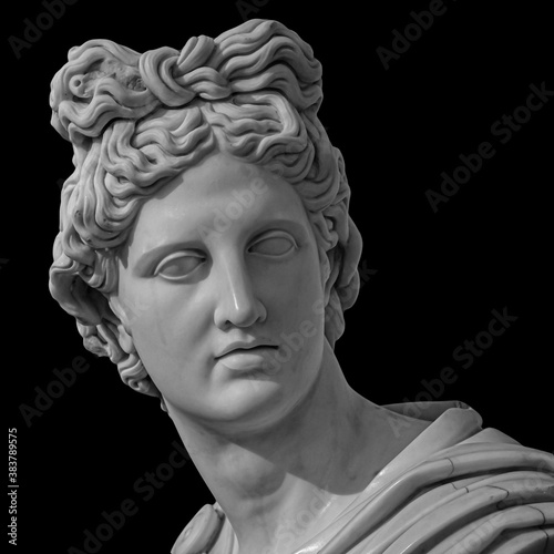 Portrait of a plaster statue of Apollo isolated on black