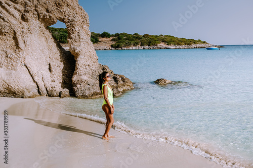 Tropical beach of Voulisma beach, Istron, Crete, Greece ,Most beautiful beaches of Crete island -Istron bay near Agios Nikolaos. young woman on the beach of Crete photo