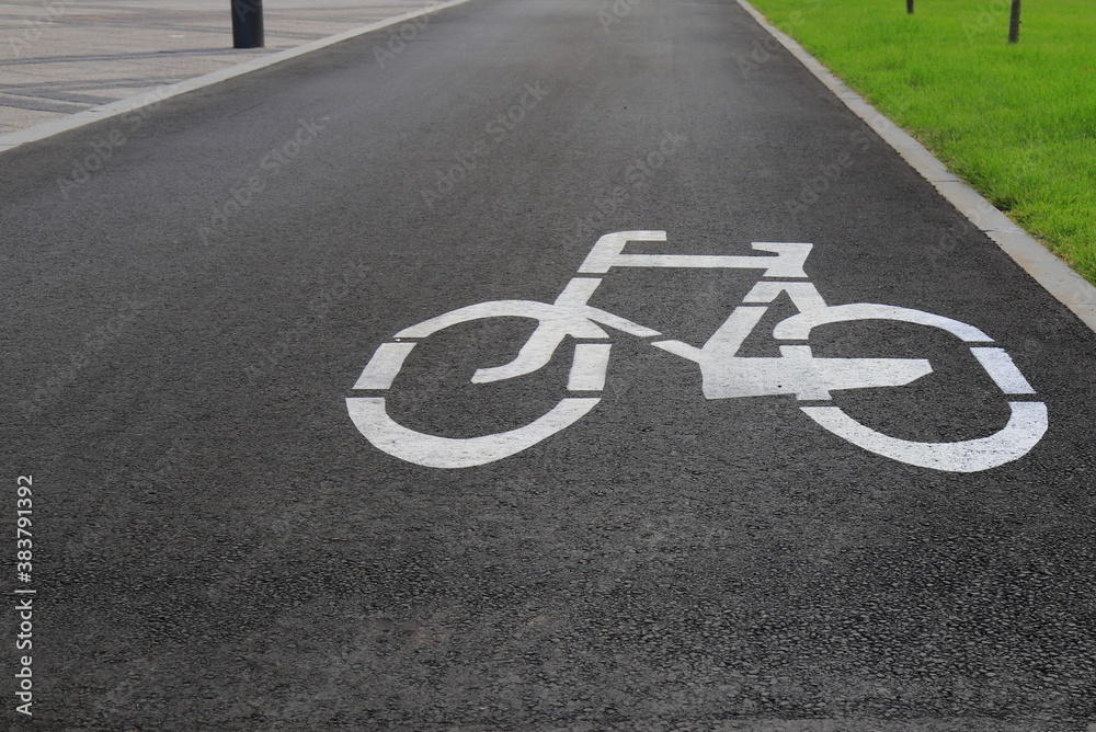 Fototapeta premium White drawn bike sign on the asphalt. Separate cycle path for cyclists, environmentally friendly urban transport for Sport . Dnepropetrovsk, Dnipro city, Ukraine
