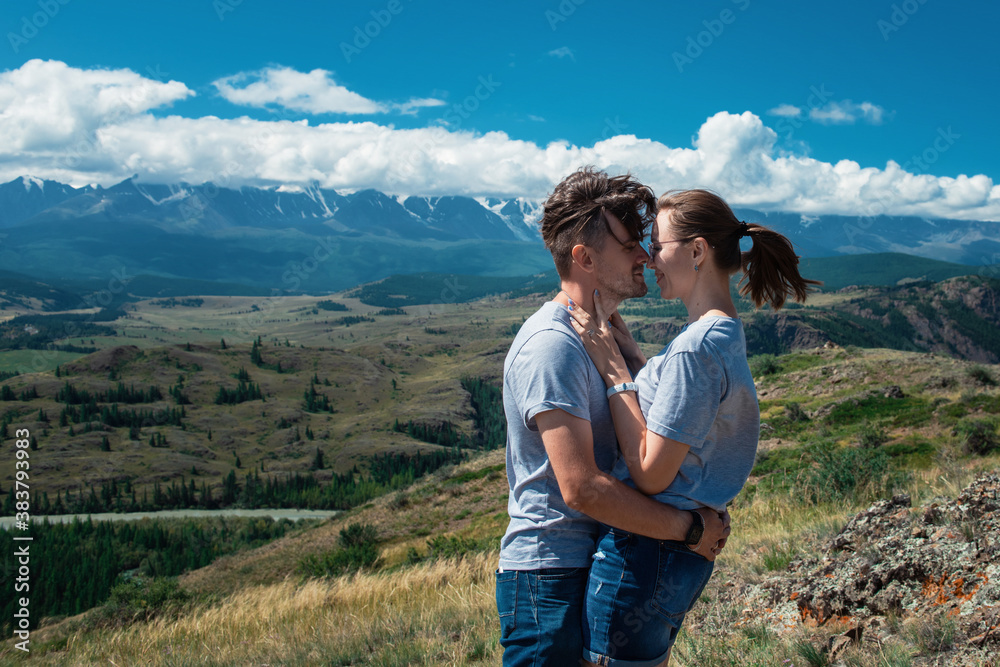 Loving couple together on Altai mountain looking at a view