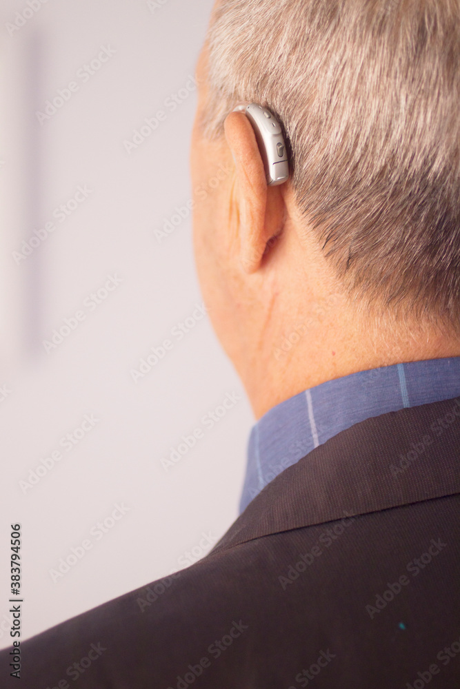 Man with hearing aid Man with hearing aid