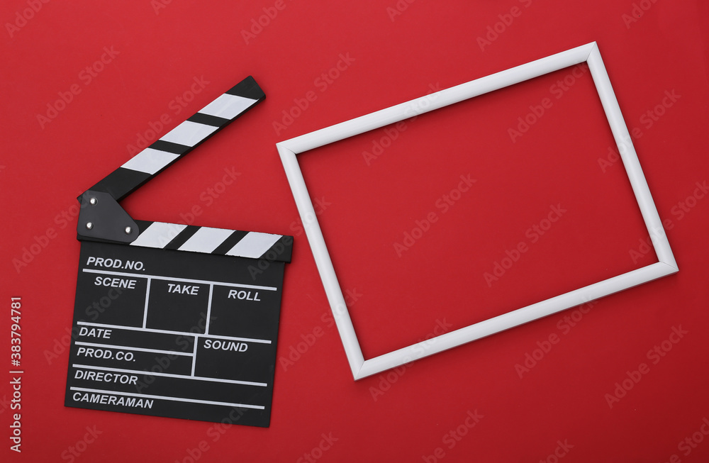 Film clapper board with white frame for copy space on red background. Cinema industry, entertainment. Top view